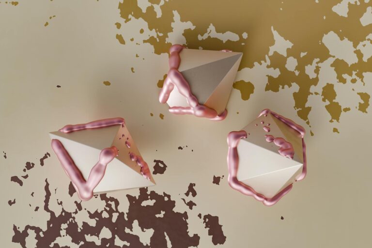 Abstract 3D cones with pink fluid accents creating a surreal visual on a textured background.